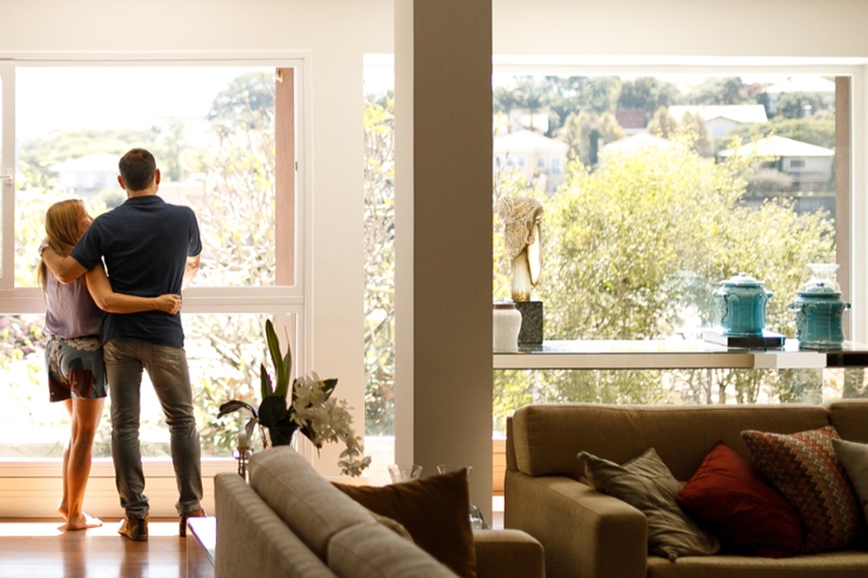 As the temperatures begin to rise in Boerne, many homeowners are firing up their air conditioners for the first time in months. But what if, instead of a refreshing blast of cool air, you’re hit with an unpleasant smell? Photo of a couple admiring the view outside of their living room window.